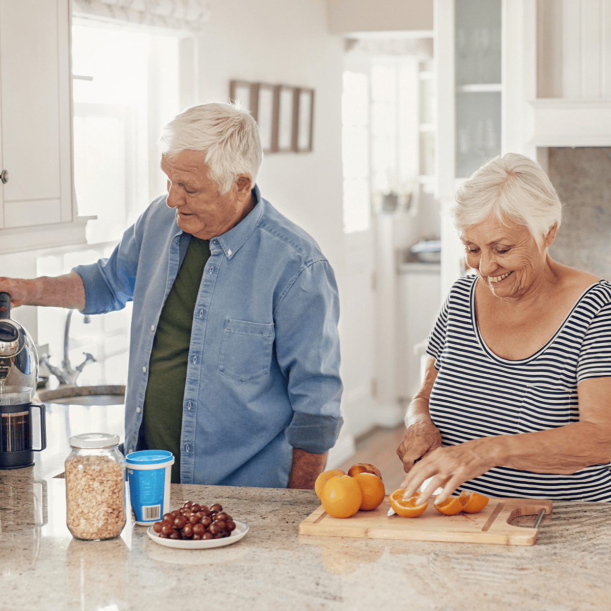 Senior couple preparing breakfast together