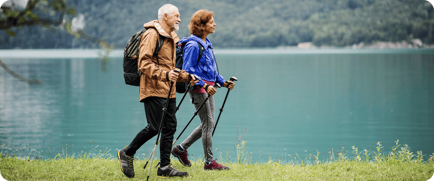 J3577_Header 1 Senior couple hiking with hiking poles