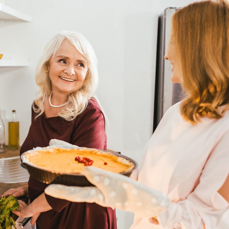 J2642-Main-Image-Senior-Cooking1200x1200-780×780 Senior mother and daughter cooking a pie together