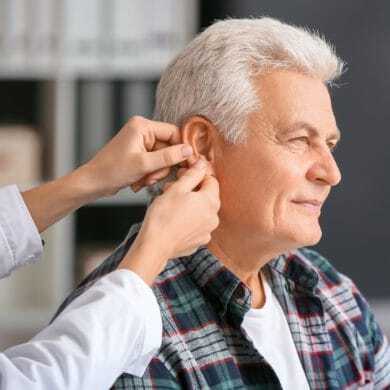 Doctor examining a senior's ear
