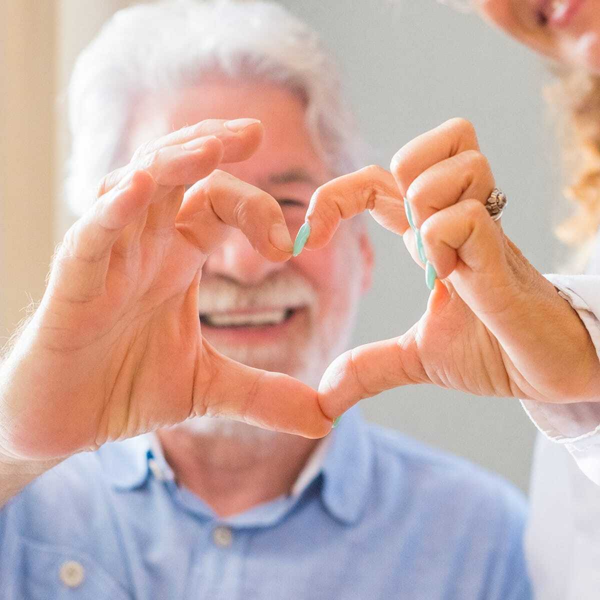 Senior couple making a heart shape with their fingers