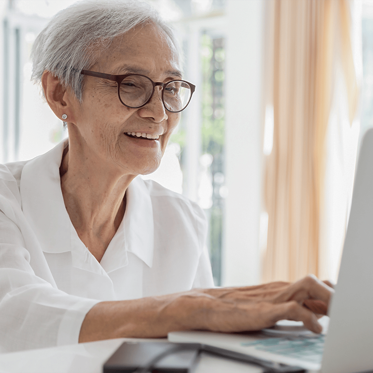 Smiling senior woman using a computer