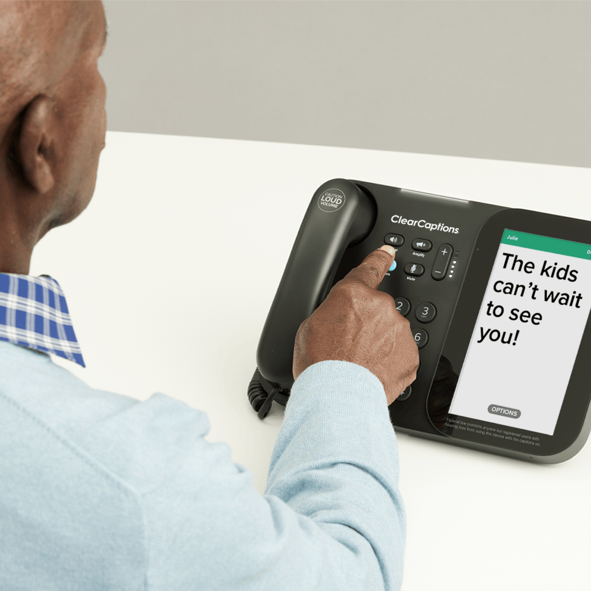 Senior man using the ClearCaptions caption phone