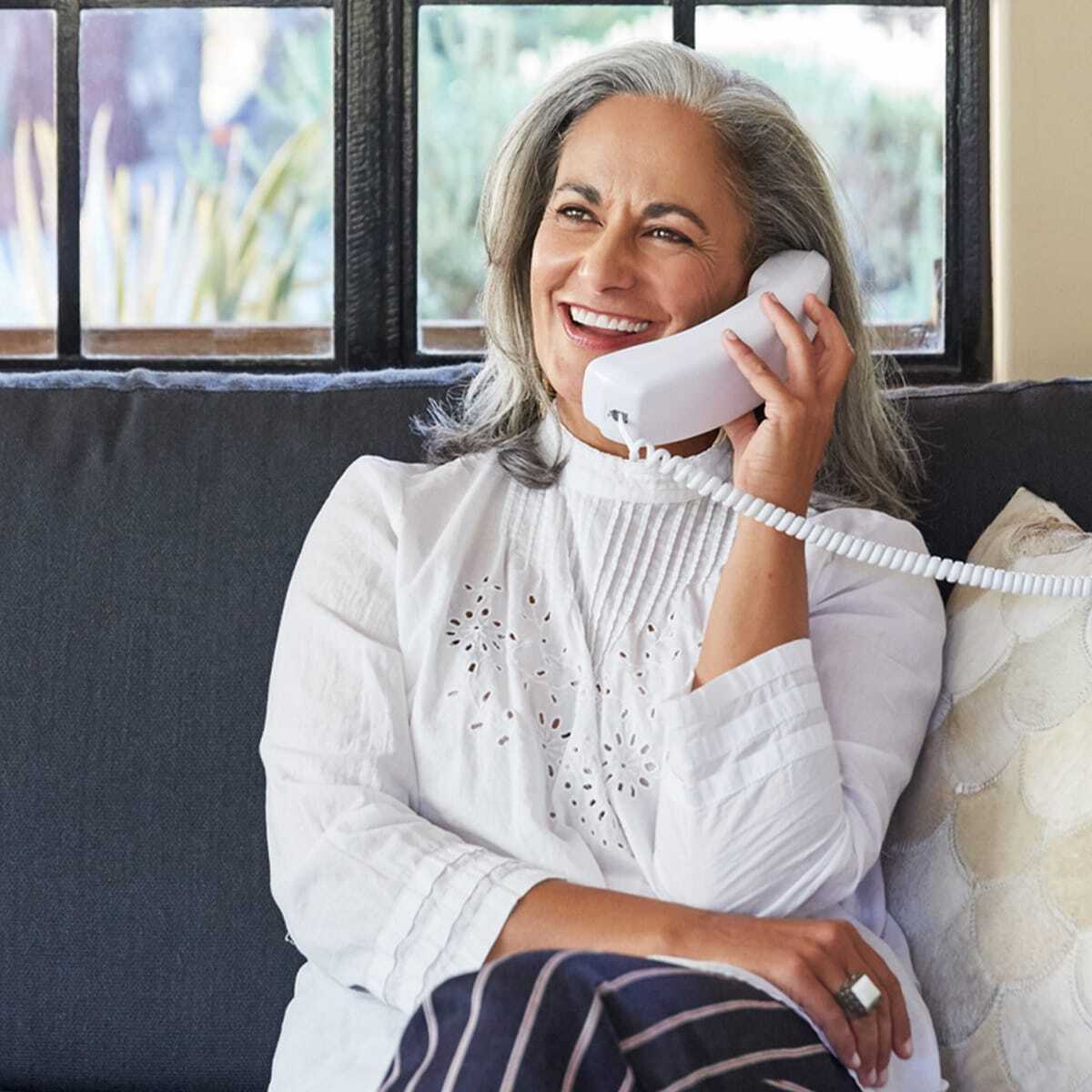 Smiling woman using a phone