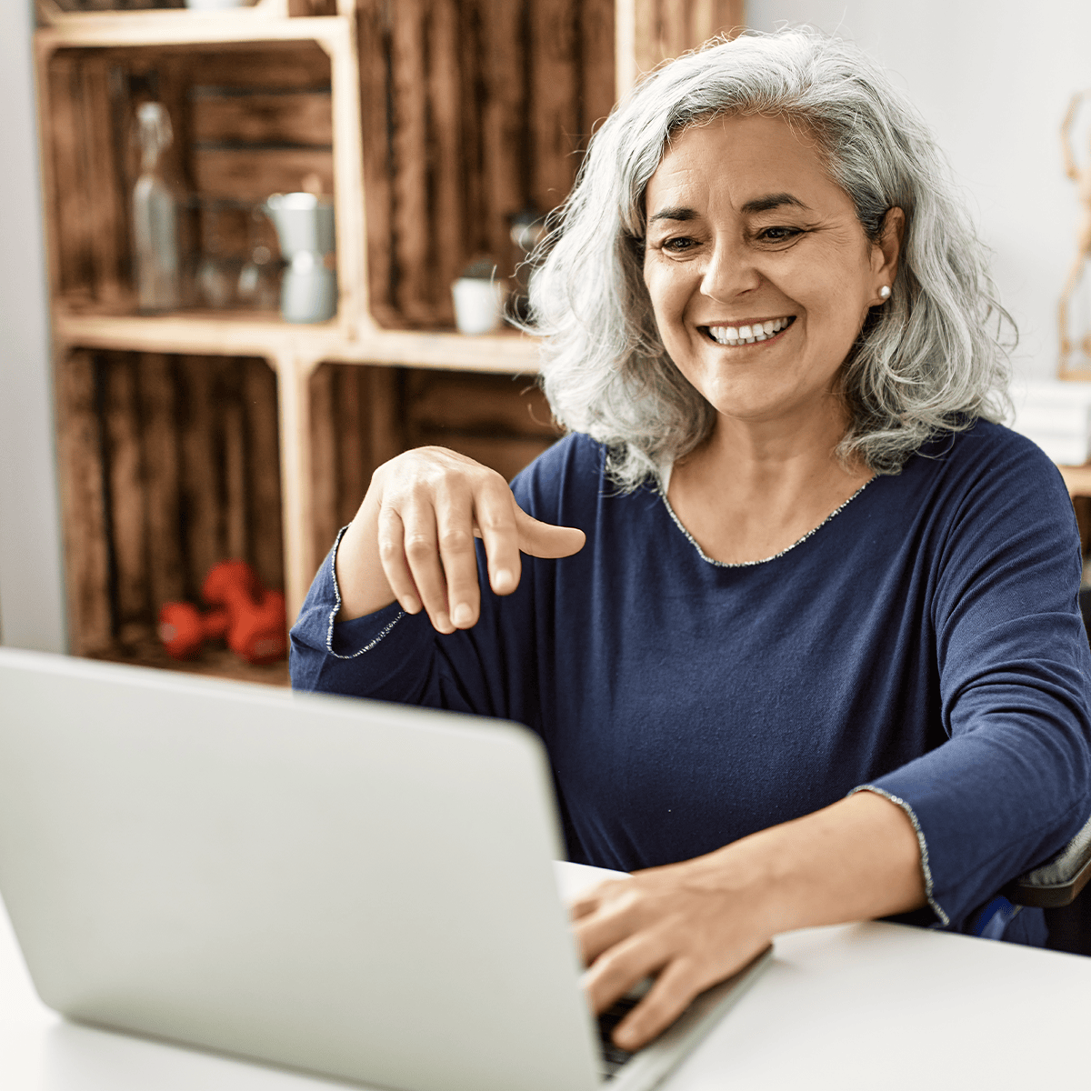 Senior woman smiling while using a notebook