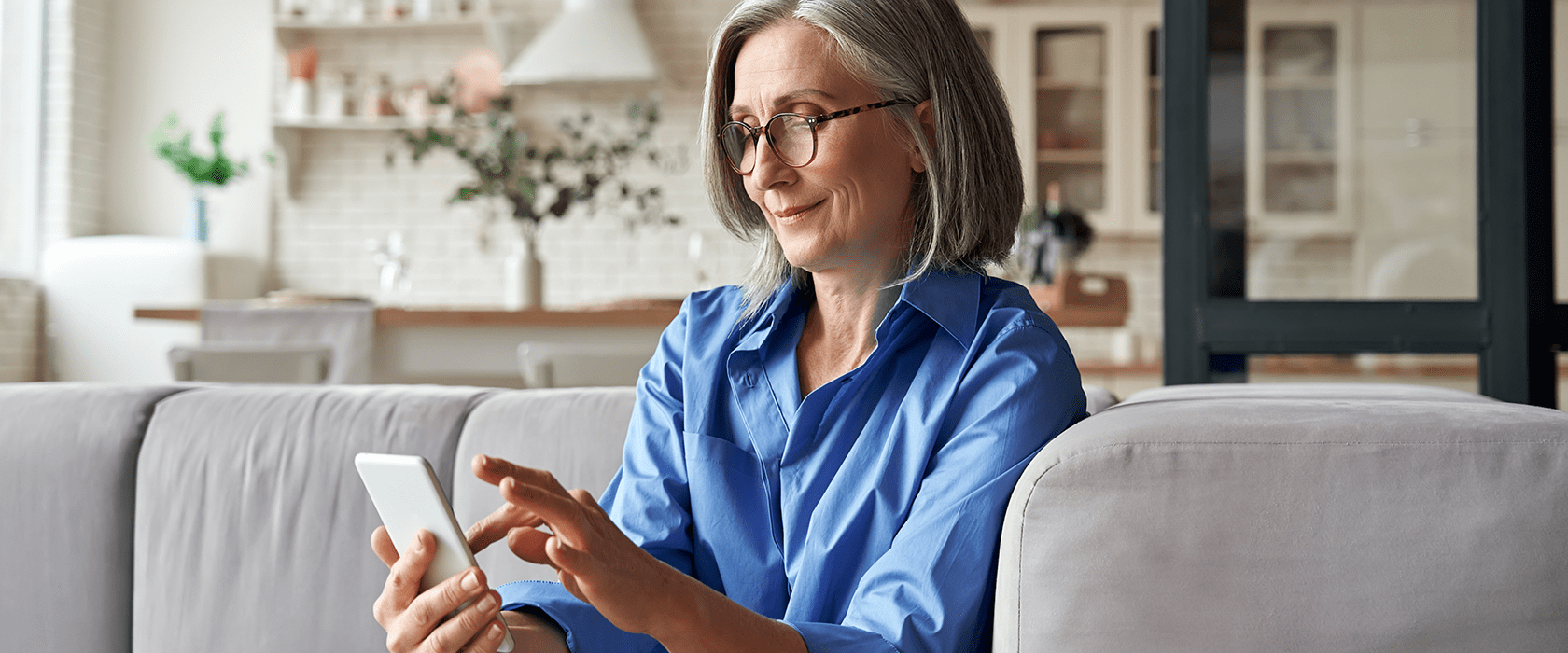 Senior woman smiling while using a cell phone
