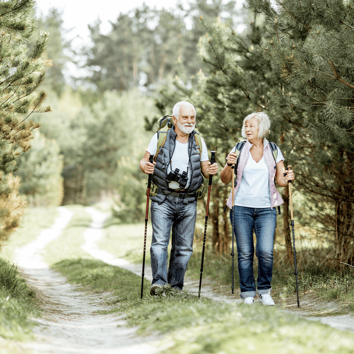 Senior couple hiking with hiking poles