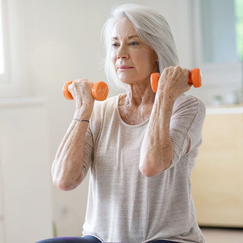 Senior woman performing dumbbell exercises