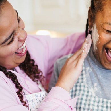 Daughter and mother having fun while cooking together