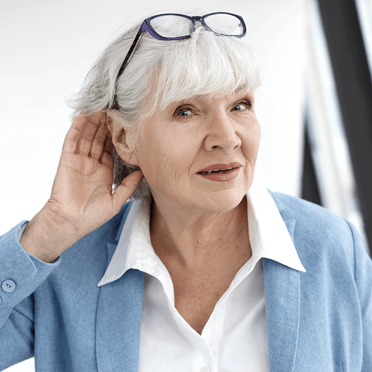 Senior woman cupping her ear to listen better